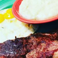 Steak & Eggs · 6 oz NY Strip steak grilled to medium rare, served with two eggs and creamy dreamy grits.