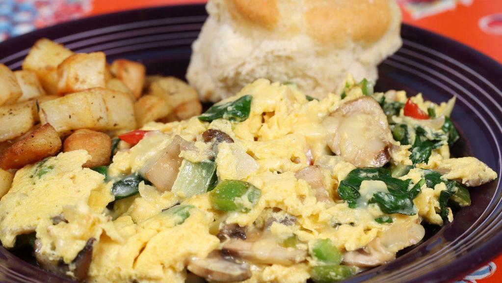 Garden Fresh Veggie Scramble · 3 eggs scrambled with onions, red and green peppers, spinach, mushrooms and white cheddar cheese, served with choice of side and a fluffy flying biscuit.