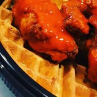 Hot Chicken And Waffle · A homemade golden Belgian waffle topped with our signature hot chicken tenders. Served with ...