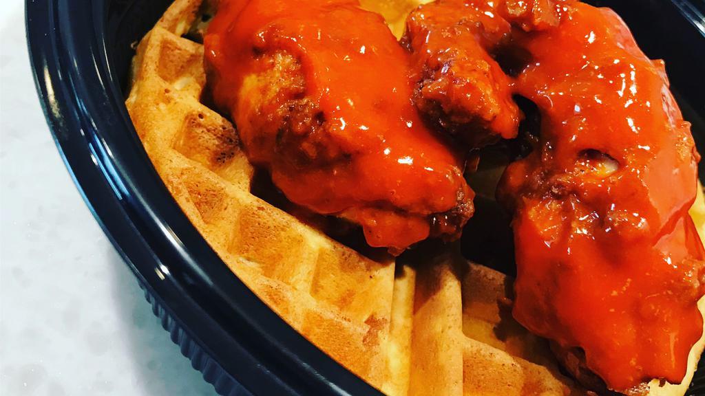 Hot Chicken And Waffle · A homemade golden waffle topped with 3 crispy buttermilk chicken tenders dipped in our signature hot sauce.