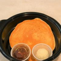 One Fluffy Buttermilk Pancake · Served with butter and syrup.
