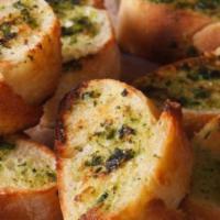 Garlic Bread · Dough rolled up and topped with a mixture of garlic oil and Parmesan cheese on top.
