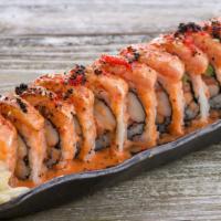 Zen Roll · Salmon, spicy crab, avocado, and cream cheese top with torches salmon belly and sauce.