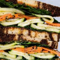 Zucchini Sandwich · Shaved zucchini, cured carrots, tomato jam, chimichurri, spinach, rye bread