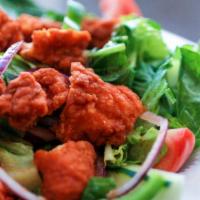 Buffalo Chicken Salad · Lettuce layered with fried chicken, tomatoes, onions, green peppers, and cucumbers.
