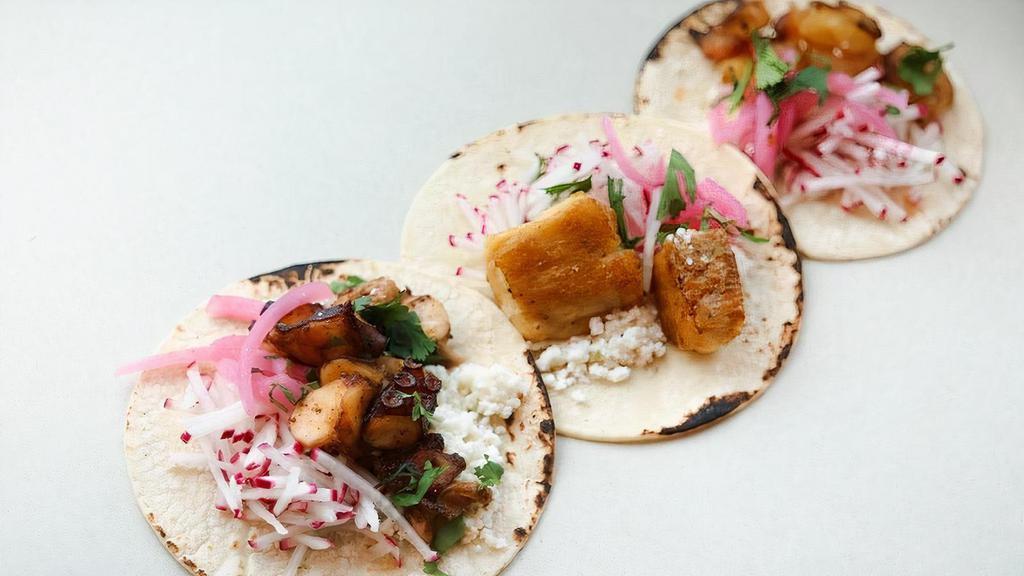 Three Tacos · Queso fresco, pickled red onions, cilantro, radish and option of lime-sliced popcorn or chips.