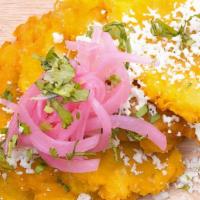 Tostones · Crispy, crunchy tostones topped with queso fresco & pickled red onions.