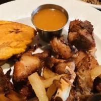 Griot · Flash fried pork seasoned to perfection cured onions, black mushroom rice, plantains.