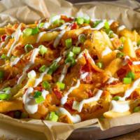 Bacon Cheese Fries · Because why not add bacon? Our fries topped with a generous portion of cheddar jack cheese, ...