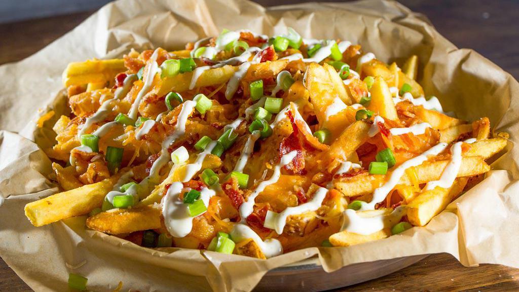 Bacon Cheese Fries · Because why not add bacon? Our fries topped with a generous portion of cheddar jack cheese, a layer of chopped bacon, and fresh scallions.