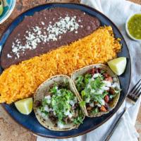 Taco Plate · (2) tacos of your choice with onions & cilantro. served with mexican  rice & refried beans