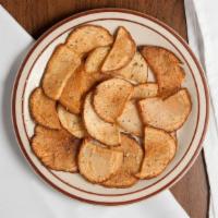 Greek Fried Potatoes · Thinly-sliced potatoes fried golden brown and dusted with our own blend of Greek spices.