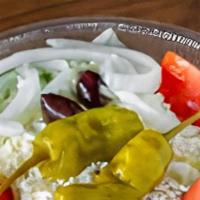 Medium Greek Salad · Iceberg lettuce, feta cheese, tomatoes, Greek peppers, kalamata olives, onions and our famou...