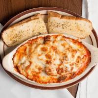 Lasagna · Served with Small Greek Salad and Garlic Bread.