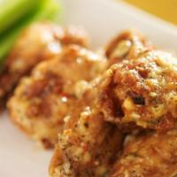 Garlic Parmesan Bone-In Wings · Delicious traditional wings tossed in garlic parm sauce made to perfection and crisp.