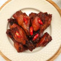 Hot Bone-In Wings · Delicious traditional wings tossed in hot sauce made to perfection and crisp.