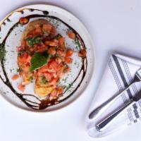 Bruschetta Al Pomodoro · On the vine ripe tomatoes, extra virgin olive oil, basil, and Spanish red onions.