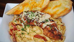 Blackened Chicken Pasta · Blackened grilled chicken breast over fettuccine pasta and sundried tomatoes in a Cajun crea...