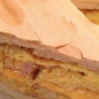 Pan Con Tortilla · Scrambled eggs with ham and cheese, onions on Cuban bread.