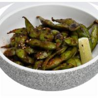 Edamame Al Wok · Edamame, aji amarillo, aji panca,. sesame oil, soy.