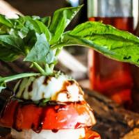 Insalata Caprese · Slices of tomato, mozzarella cheese, basil leaves, olive oil, and a touch of balsamic vinega...
