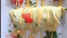 Eggchilada Health Wrap · Over hard eggs, avocado, tomato and sour cream with cheddar cheese.