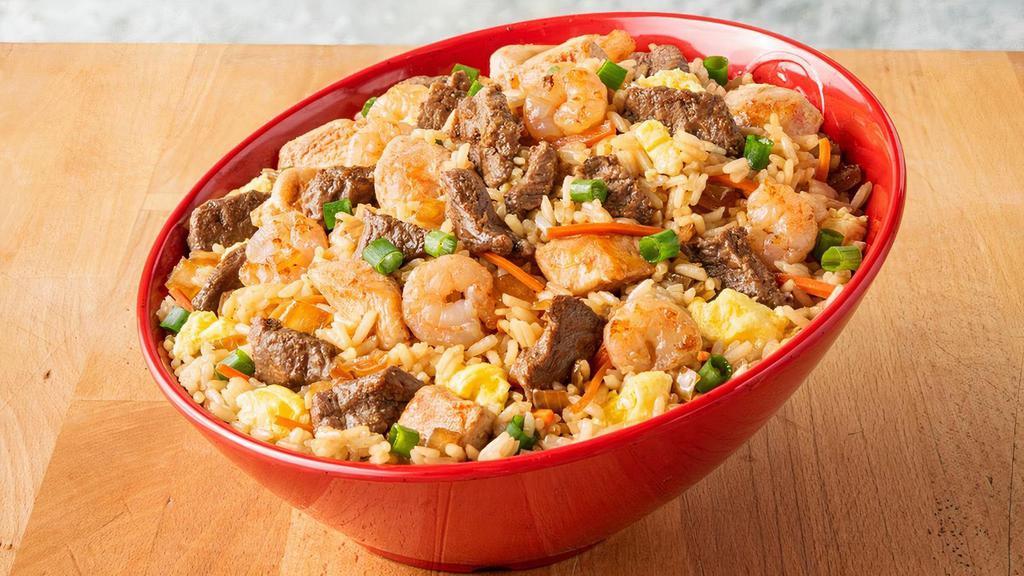 Supreme Fried Rice · Premium steak, marinated chicken and fresh shrimp reign supreme in this fried rice bowl, served with onions and egg.