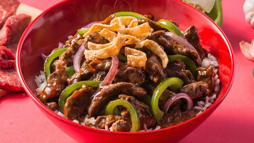 Mongolian Steak · Chili-marinated steak with roasted red peppers, green bell peppers, onion and water chestnuts in our signature Mongolian BBQ sauce with white rice or your choice of base. Topped with wonton strips.