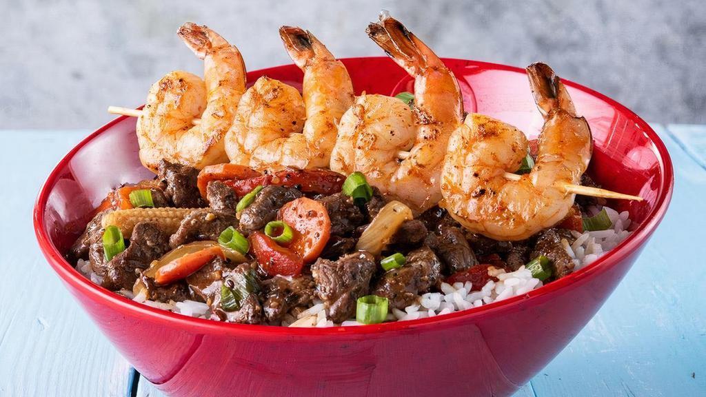 Surf N Turf · The latest Chef-made bowl to our lineup combines premium Beef and our new jumbo Shrimp Skewers with red peppers, baby corn, green and yellow onions, carrots in a delicious Kung Pao sauce, served on white rice or your choice of base.