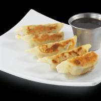Chicken Potstickers · Kick things off with all white meat chicken, scallions, cabbage and water chestnuts stuffed ...