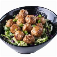 Saucy Balls – Hot · A dozen juicy, plump meatballs smothered in Spicy Korean BBQ Sauce, served on a bed of cabba...