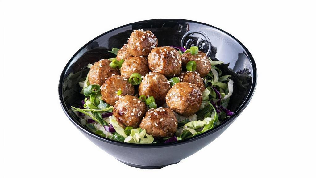 Saucy Balls – Hot · A dozen juicy, plump meatballs smothered in Spicy Korean BBQ Sauce, served on a bed of cabbage.