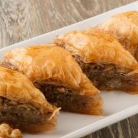 Baklava · Honey soaked filo pastry filled with layers of walnuts and almonds.