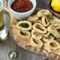 Crispy Calamari · Lightly Seasoned and fried calamari, served with a side of our signature marinara sauce and ...