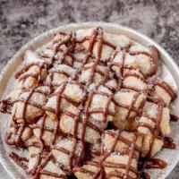 Angioletti Con Nutella · Fried pizza dough with a drizzled Nutella and powered sugar finish.