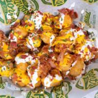 Loaded Tots · Crispy golden tater tots topped with cheddar cheese, sour cream and bacon crumbles. Yum!