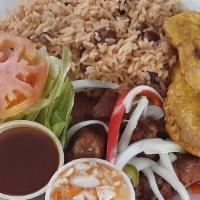 Griot Comple (Fries Pork) · Thick cut fries pork serve with white rice or mix rice with bean a small salad, plantain and...
