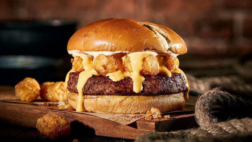The Bayou Burger · A nice, meaty Chuck Burger with seasoned tater tots, Cajun seasonings and Cajun mayo with cheese sauce. Napkins a must. Dozens of them. Seriously.