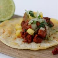 Al Pastor Tacos · Marinated roasted pork, pineapple, onions, cilantro, green salsa.
