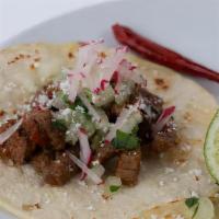 Steak Tacos · Marinated steak, red salsa, onions, cilantro, radish.
