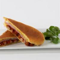 Media Noche Sandwich · Al pastor pork shoulder, sliced ham, swiss cheese, pickles, yellow mustard on sweet roll.