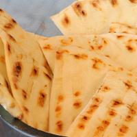 Pita Bread · A delicious piece of fresh fire-baked pita to go with your meal.