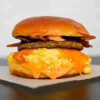 Big Breakfast Brioche Sandwich · 2 fresh cracked cage-free scrambled eggs, melted Cheddar cheese, bacon, breakfast sausage, g...
