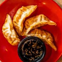 Crispy Pork Gyoza (4 Pc) · Fried pork dumpling served with house-made ginger-soy dipping sauce