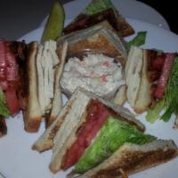 Homemade Sliced Turkey Club Sandwich · All white meat. Crisp bacon, lettuce, and tomato. Served with coleslaw and pickle.