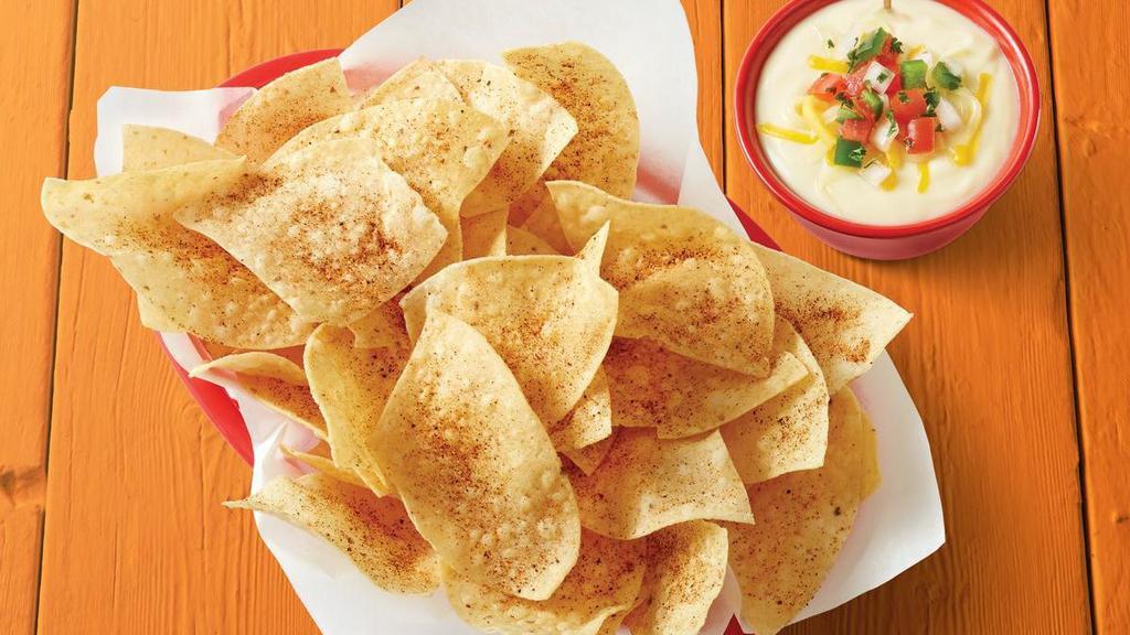 Chips & Queso · Basket of fresh tortilla chips seasoned with Fuzzy Dust and served with Queso.. {GF - please note that chips are fried in a fryer that may allow cross-contact in some locations}