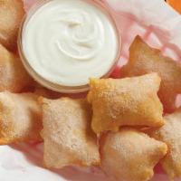 Sopapilla Bites · Freshly cooked bite-size sopapillas sprinkled with cinnamon-sugar and served with sweet vani...