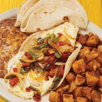 Huevos Rancheros · Two fried eggs, grilled tomatoes, jalapeños, onions, on a corn tortilla, and topped with fir...