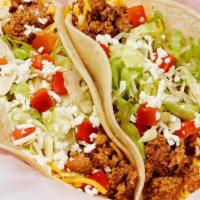 Seasoned Ground Beef Taco · Special ground beef served on a soft corn tortilla and topped with garlic sauce, lettuce, to...