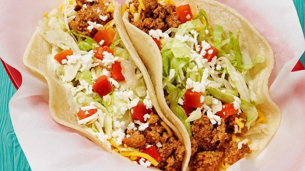 Seasoned Ground Beef Taco · Special ground beef served on a soft corn tortilla and topped with garlic sauce, lettuce, tomatoes, shredded cheese, cilantro, and feta.. {DF - remove shredded and feta cheese}
